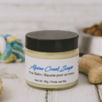 Paw Balm displayed with dog treats and dog toys